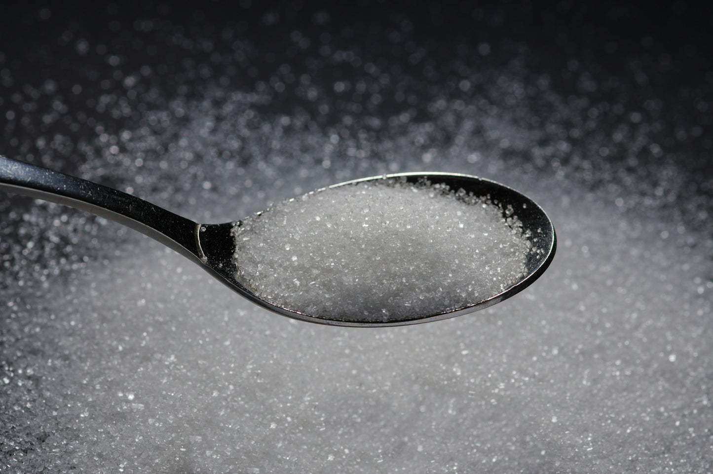 Spoonful of sugar on a dark background