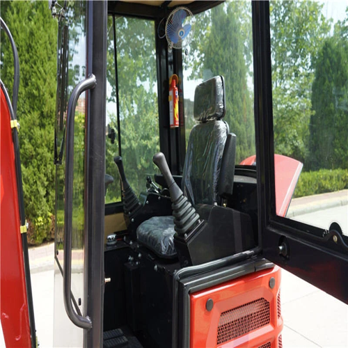 Red forklift cabin interior with steering wheel and dashboard, surrounded by greenery.